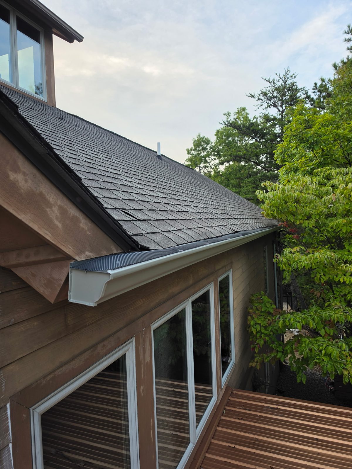 Gutter end at a roof corner of the cabin.