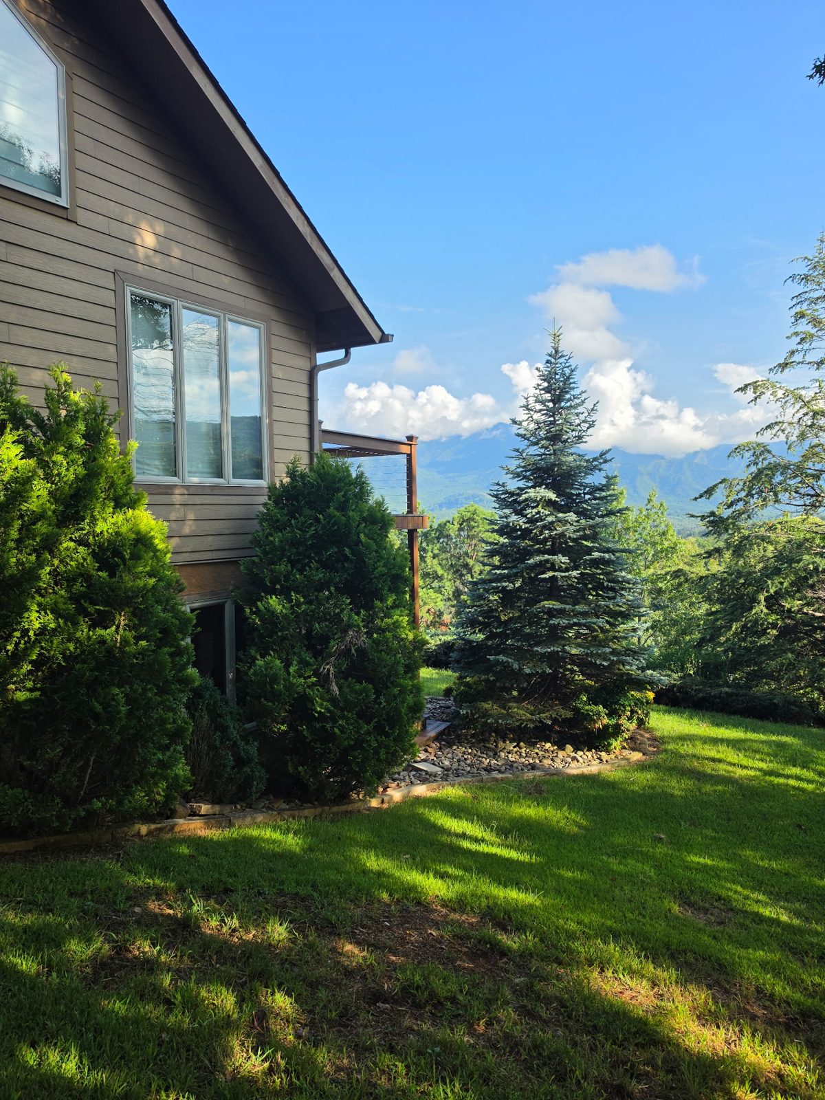Side of a Gatlinburg cabin with new gutters and a mountain view.