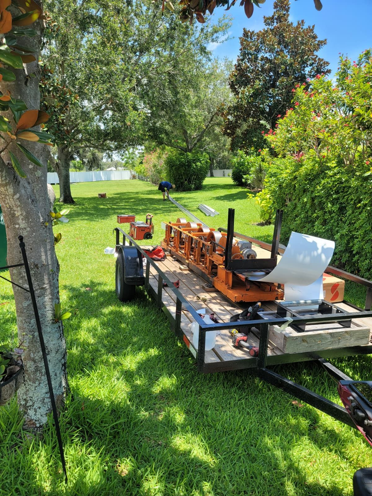 Eli’s seamless gutter machine set up on a job site, ready to roll gutter from a coil of aluminum.