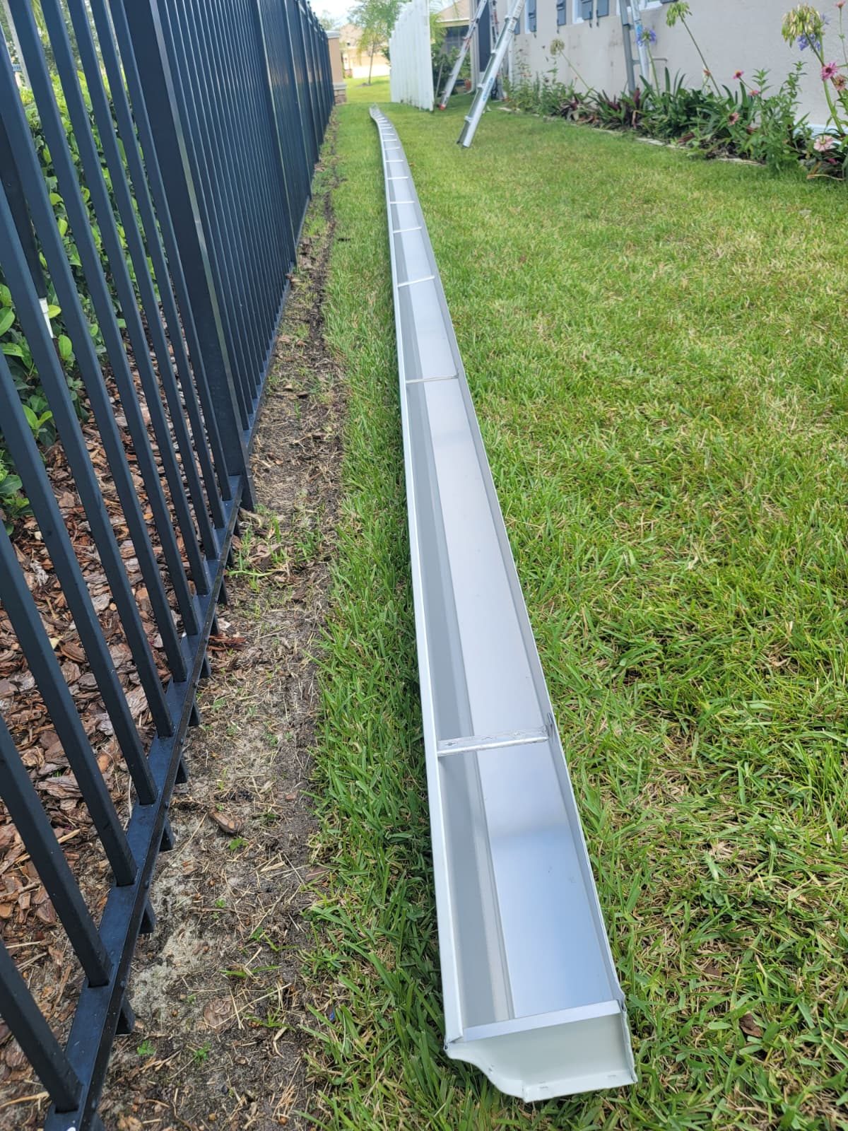 A long seamless gutter run in one continuous piece along a roof edge.
