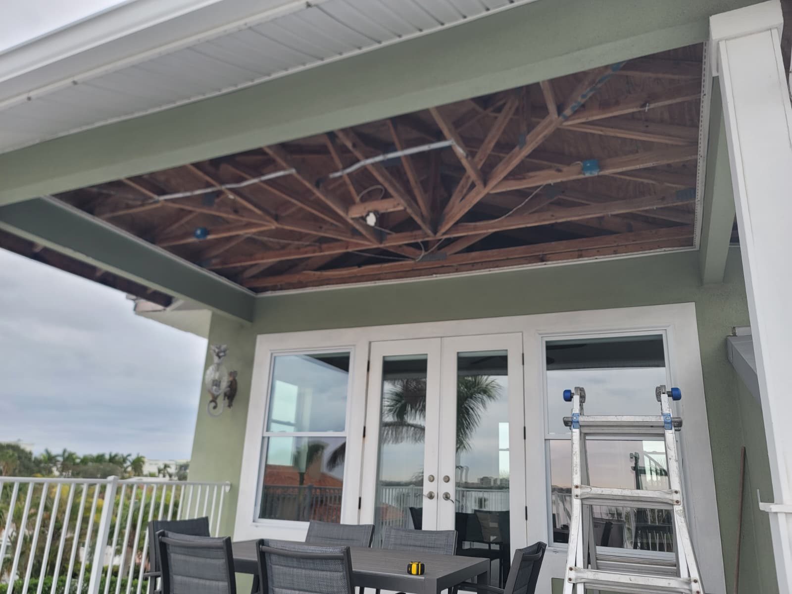 A patio ceiling soffit before the work.